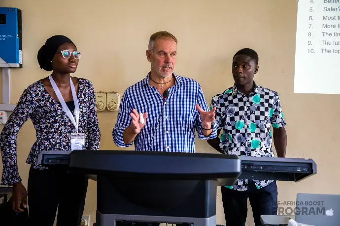 A person giving a speech with two individuals standing beside him, representing communication, leadership, and public speaking.